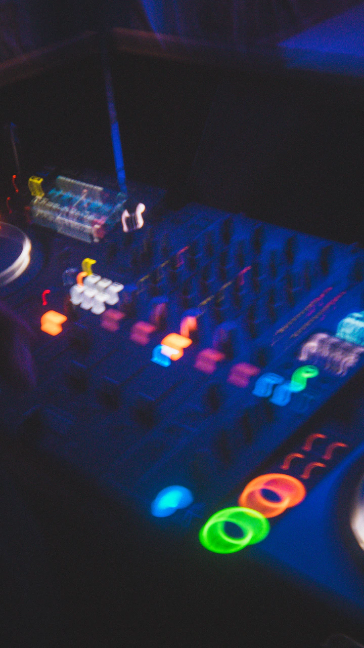 DJ mixer glowing under blue light